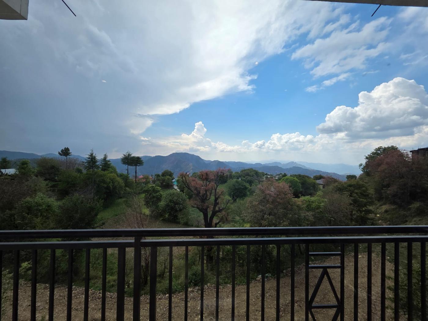 A balcony view from Rahini Sunset Villa overlooking the Himalayan ridge